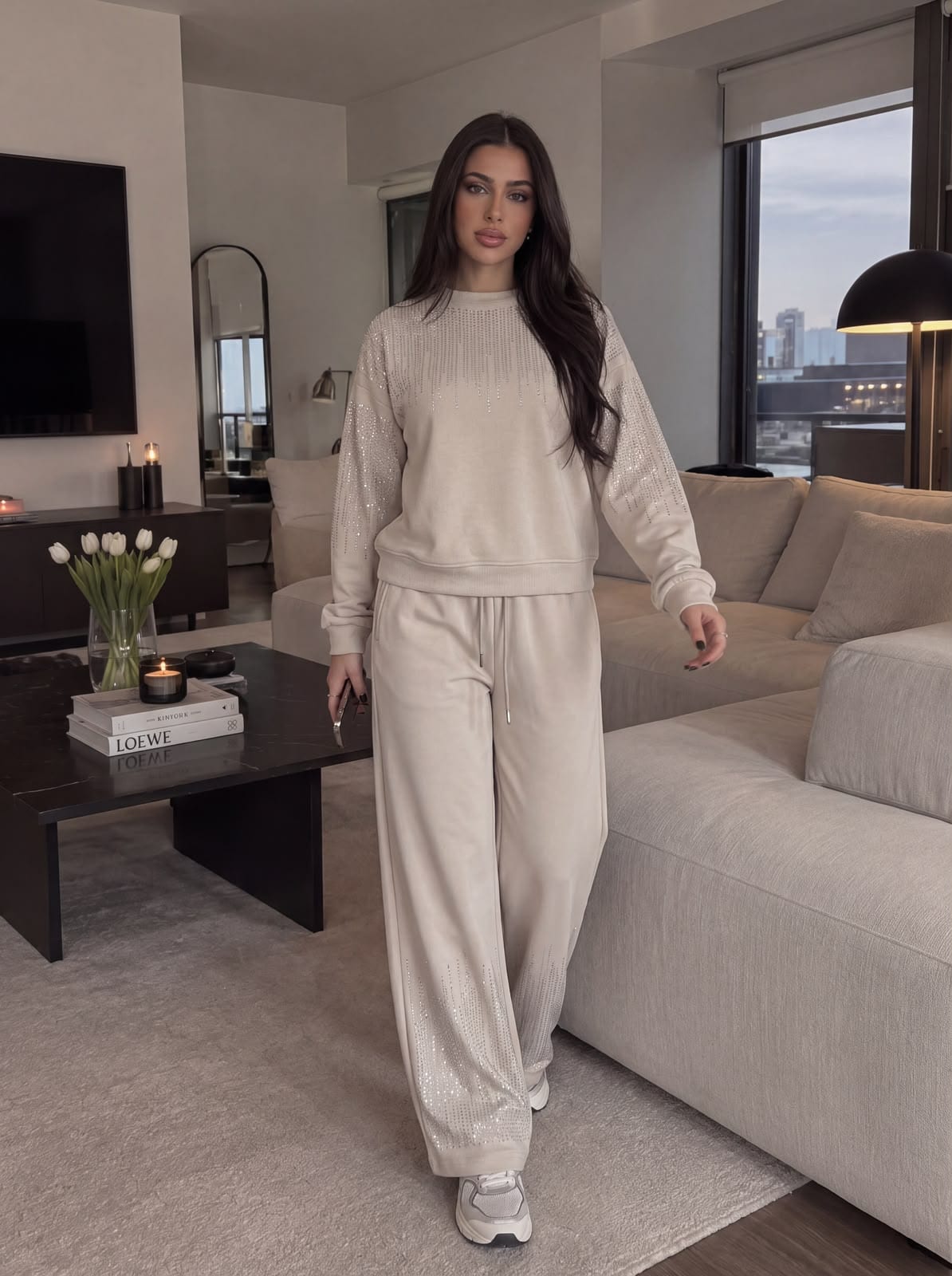 Model walking through a living room in a beige set.